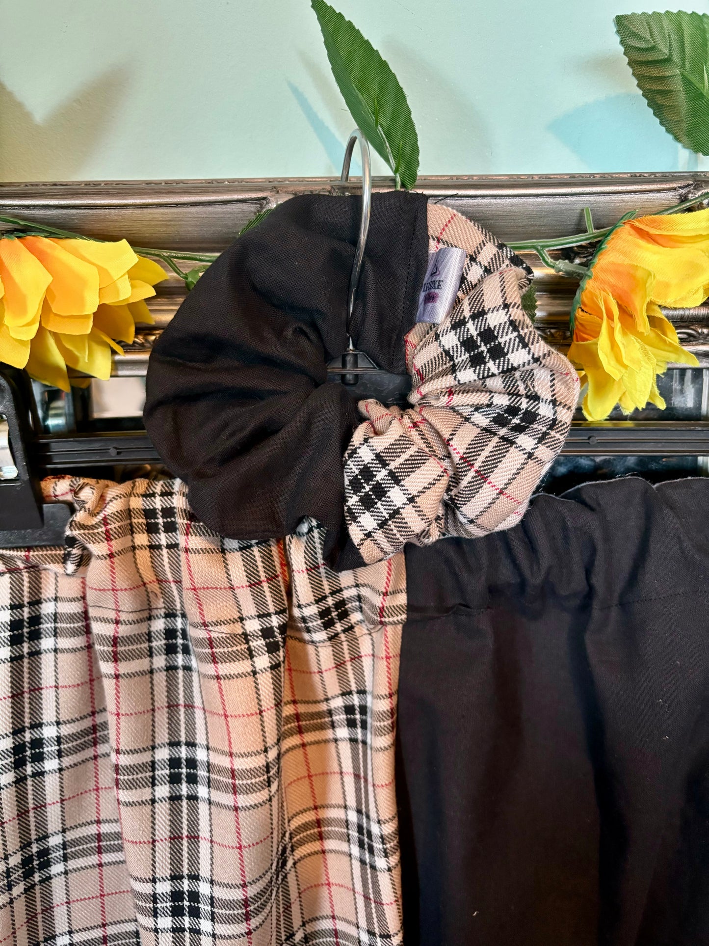 Miss matched caramel tartan and black tapered leg trousers