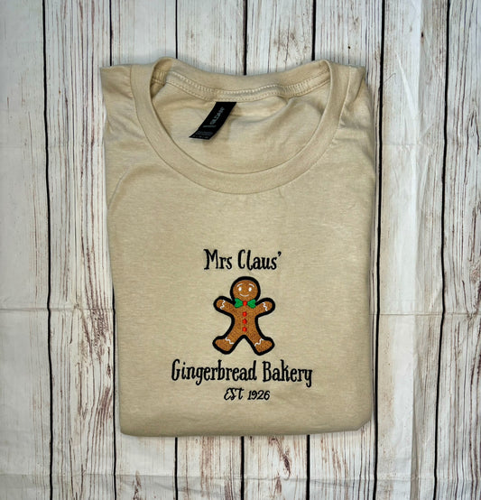 Mrs Claus Gingerbread Bakery Christmas Sand embroidered sweatshirt, hoodie, T-shirt